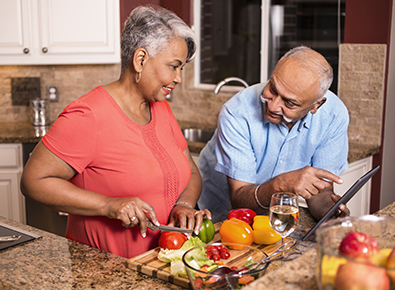 elder black couple preparing food