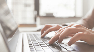 hands on laptop keyboard