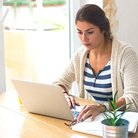 An image of a woman looking at computer