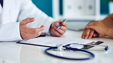 doctors hands next to stethoscope