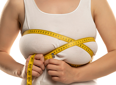 Women sizing breast for reduction. 