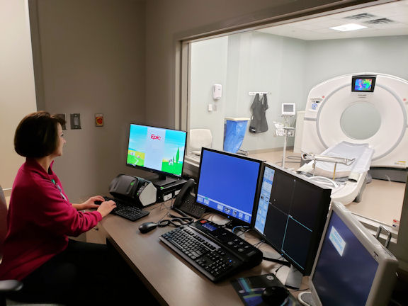 Technologist at CT scanner console