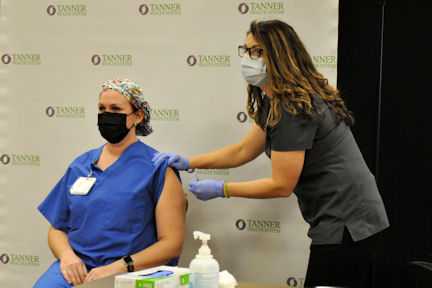 Katie Scogins, RN, getting the vaccine