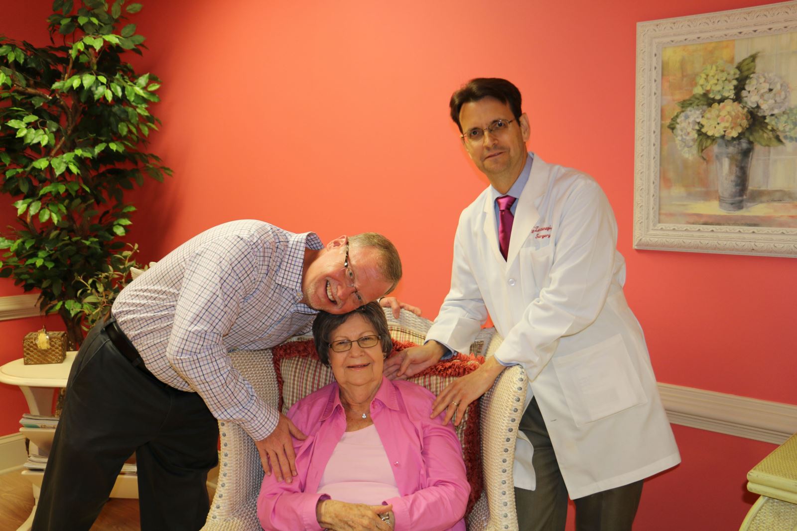 Cancer survivor Effie Wortham of Bowdon enjoys a spontaneous and very sweet moment with two members of her Tanner Cancer Care patient care team