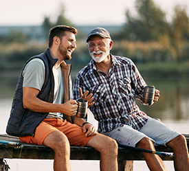 Two men sitting on a dock together