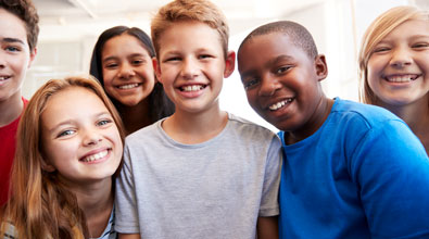 Group of diverse smiling children.