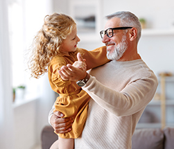 Grandfather dancing with grand daughter