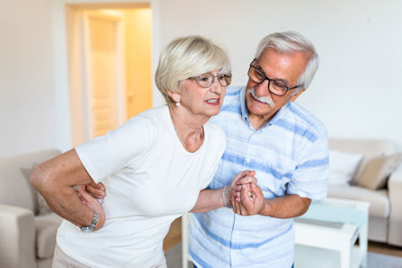 Man helping woman with back pain