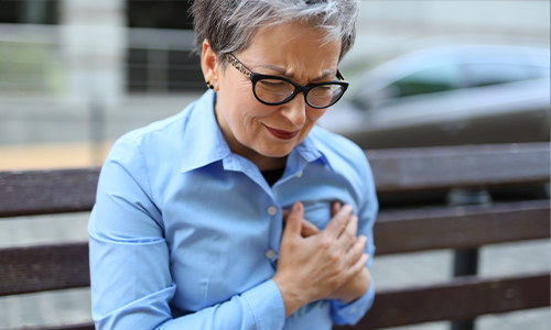 woman holding her chest in pain