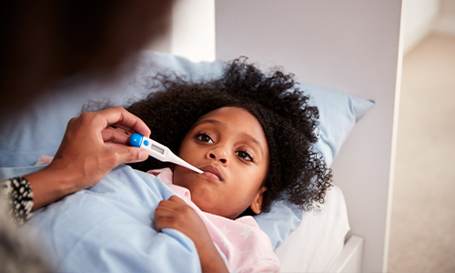 parent taking their daughters temperature 