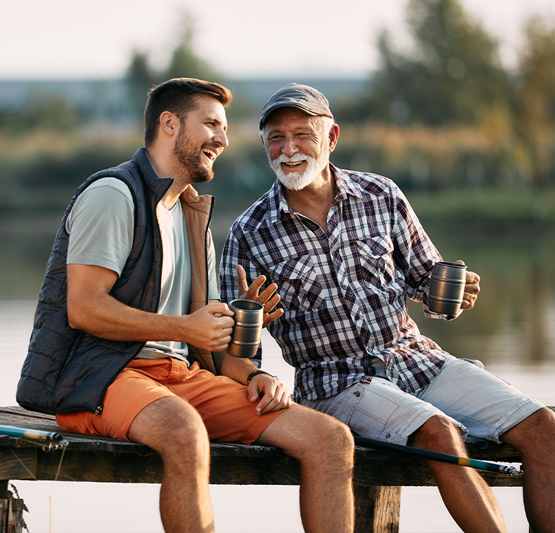 dad and son talking on a dock