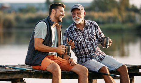 dad and son talking on a dock