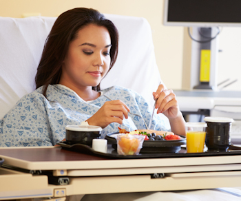 female patient eating hospital meal